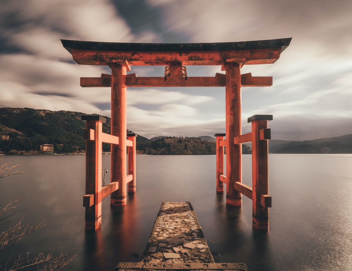 Orange arches over water leading to lake. Expansive feeling. 