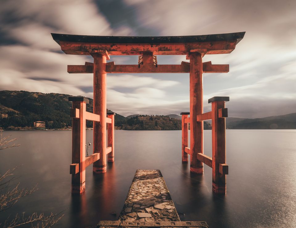 Orange arches over water leading to lake. Expansive feeling.